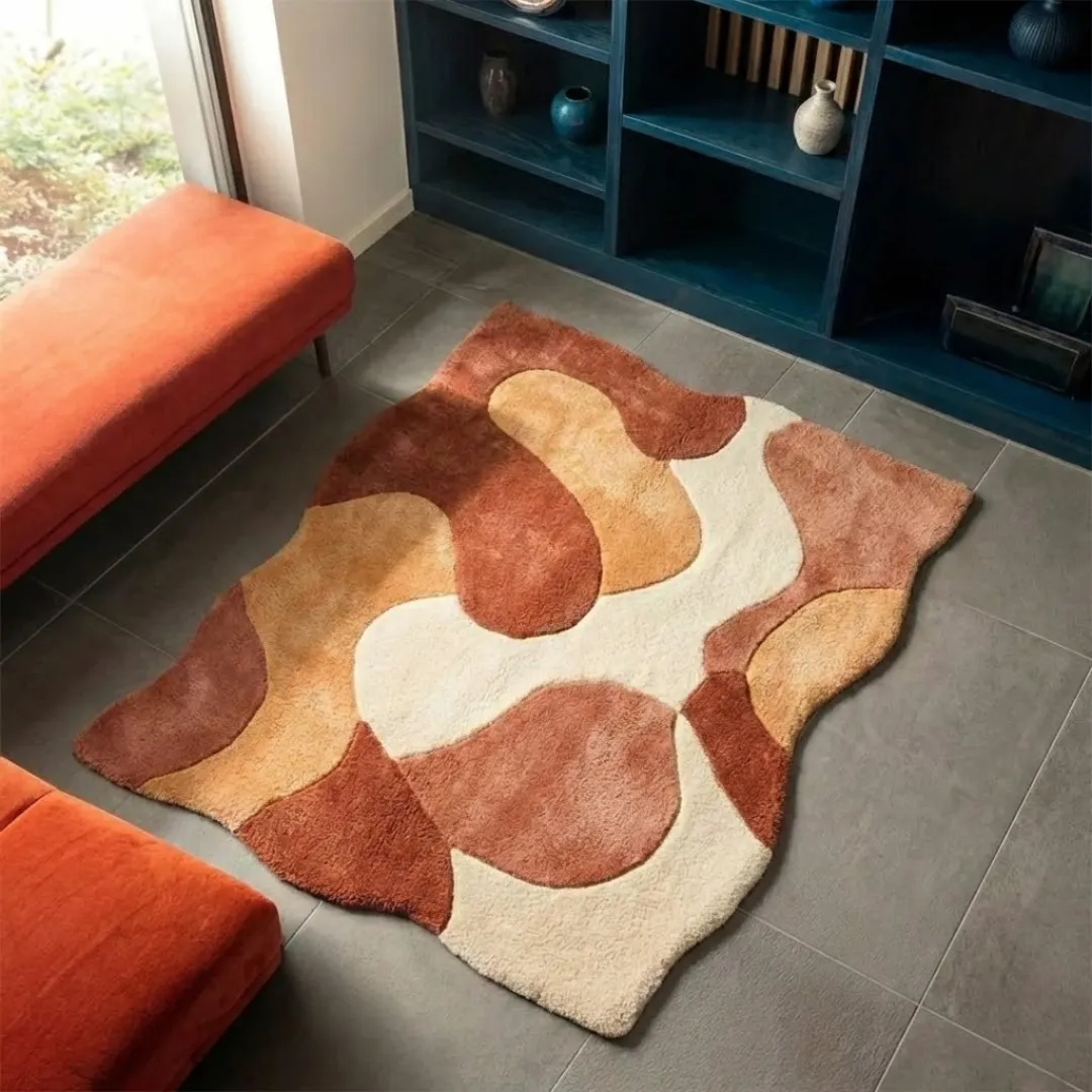 aren morph rug angle High-angle lifestyle view of the Aren Morph rug showcasing its dense, plush hand-tufted wool texture and the elegant, curved layout of its terracotta, tan, and cream fluid shapes in a sunlit modern interior.