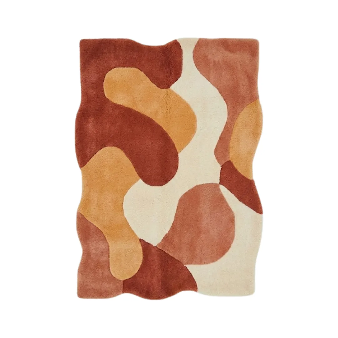 aren morph rug top Top-down view of the Aren Morph rug featuring an organic, wavy irregular silhouette and a fluid abstract pattern in warm, earthy shades of terracotta, mustard, and cream.