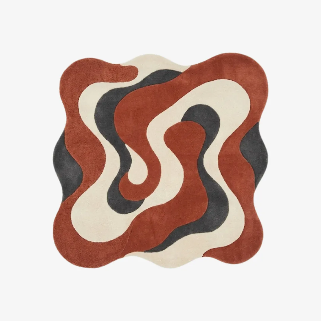 cavaro flow rug top Top-down view of the Cavaro Flow rug featuring an organic, wavy irregular silhouette and a dynamic swirling pattern in dark terracotta, charcoal grey, and cream.