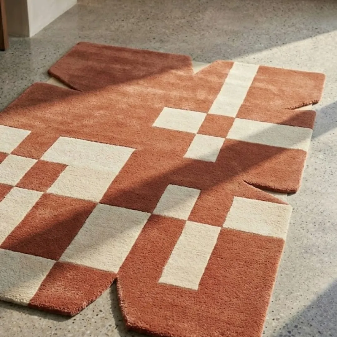 desert codec rug texture Close-up view of the Desert Codec rug, highlighting the dense, plush hand-tufted wool texture and the clean lines of the terracotta and ivory geometric design.