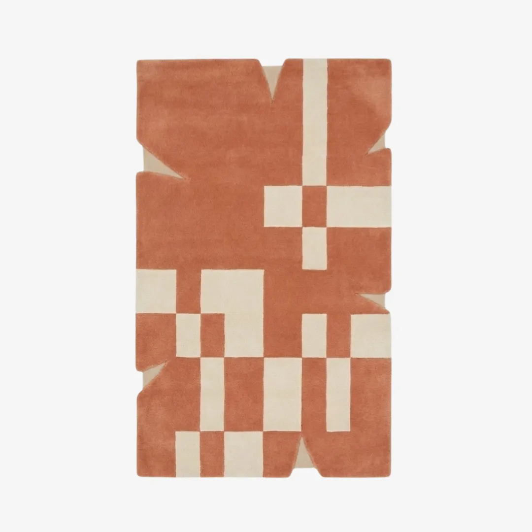 desert codec rug top Top-down view of the Desert Codec rug featuring a warm terracotta background with ivory geometric blocks and a unique, notched irregular silhouette.
