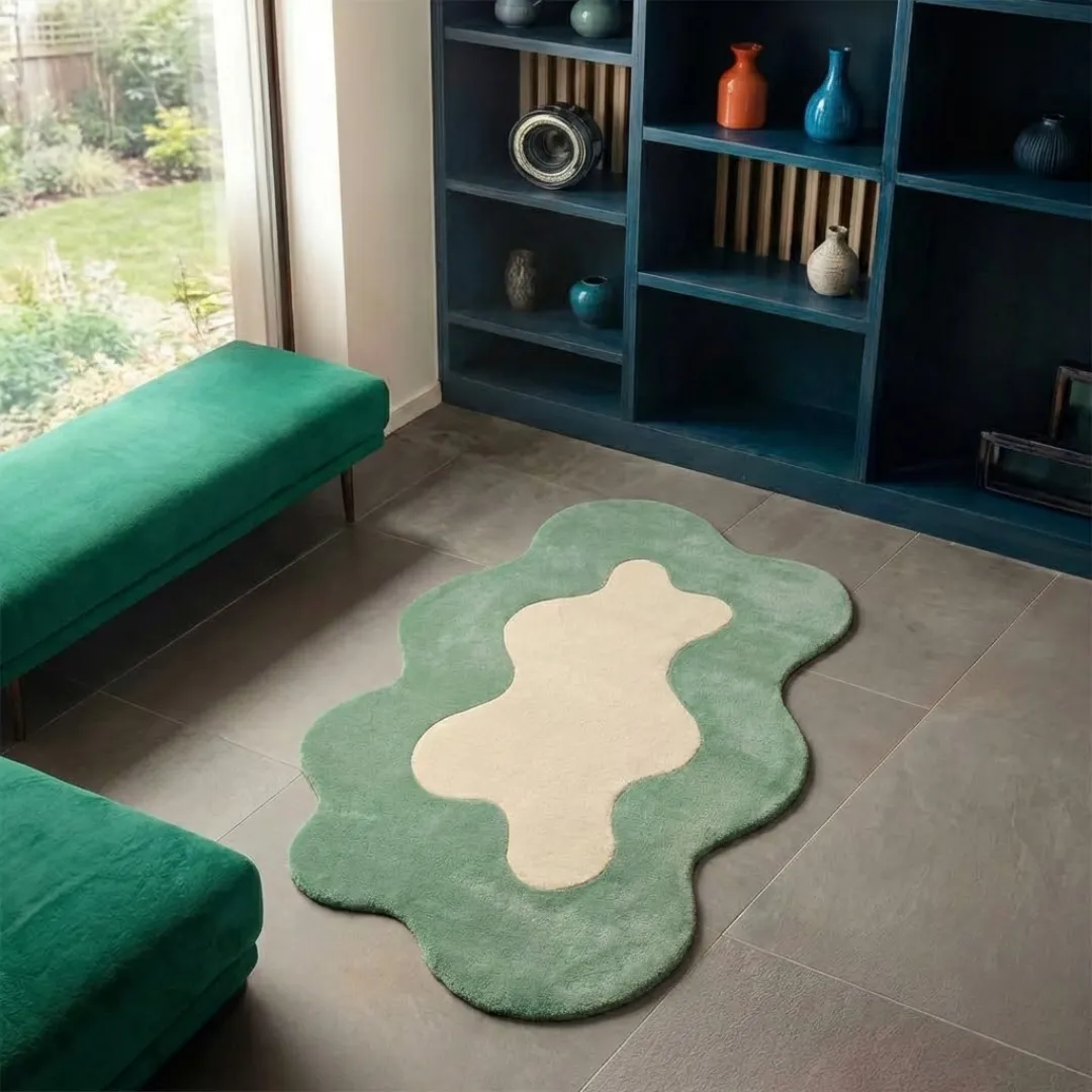 liom mist rug angle High-angle lifestyle view of the Liom Mist rug, highlighting its dense, plush hand-tufted wool texture and elegant, curved design in a sunlit interior with a garden view.