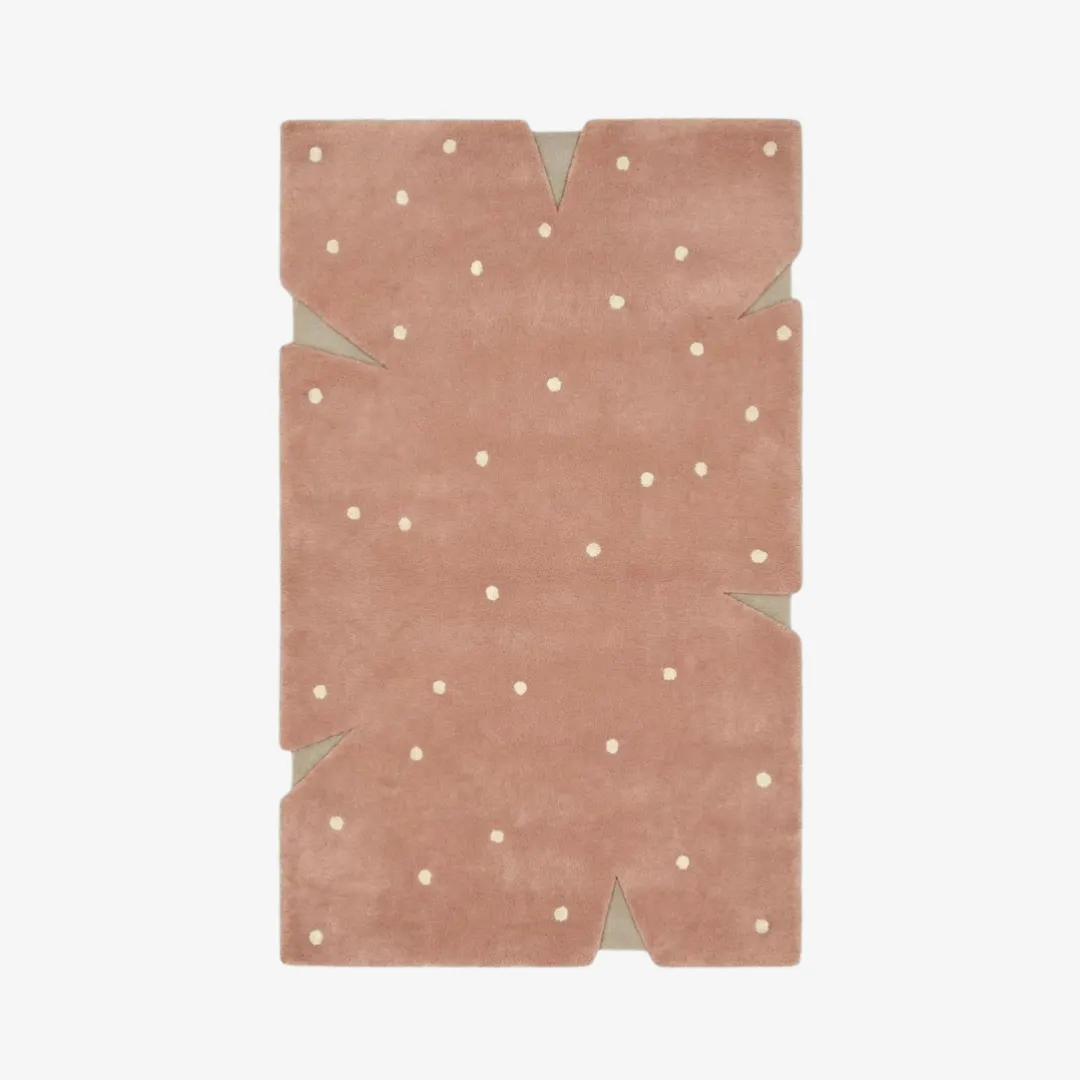 rosie stone rug top Top-down view of the Rosie Stone rug featuring a soft dusty pink field with ivory polka dots and a unique, notched irregular silhouette.