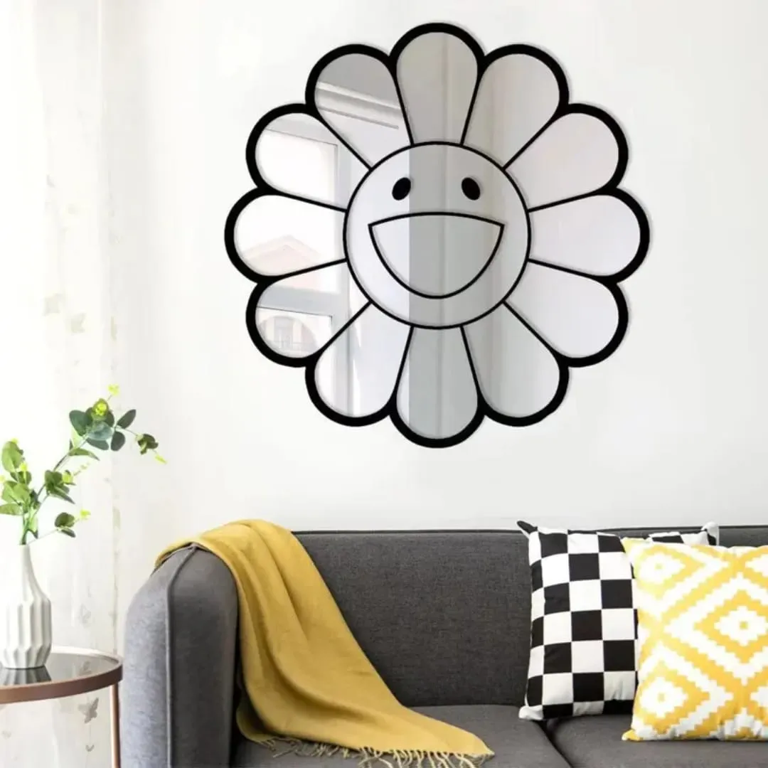 smiley daisy mirror living room sofa decor The smiley daisy mirror hung on a white wall above a grey sofa styled with a yellow throw blanket and patterned pillows, reflecting a bright window and natural light.