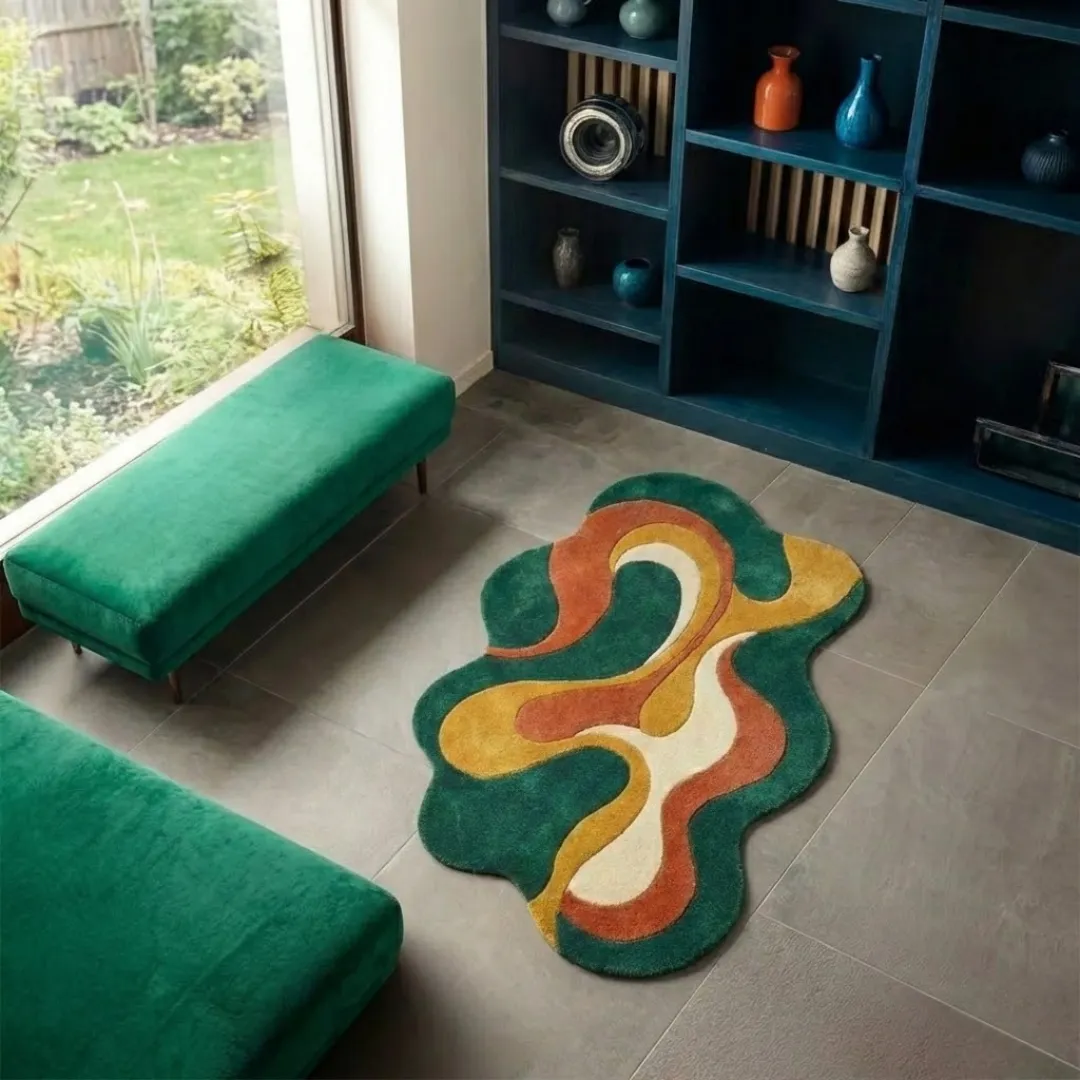 viral wave rug angle High-angle lifestyle view of the Viral Wave rug showcasing its plush hand-tufted texture and unique irregular shape in a sunlit interior with a modern shelving unit and garden view.