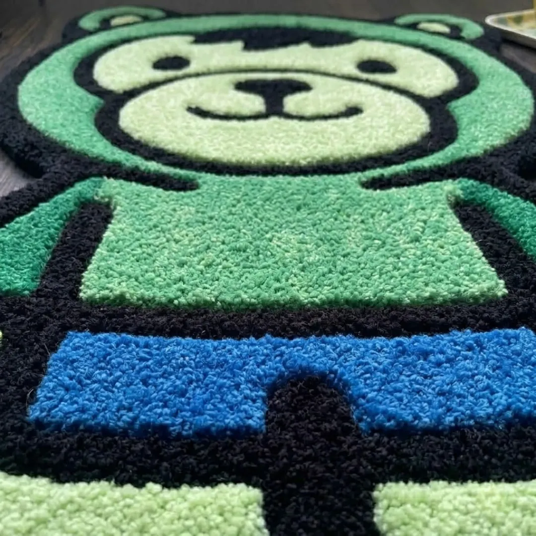 gamma fury rage shaped area rug texture close up A macro close-up of the gamma fury rage rug, focusing on the dense, tufted wool pile and the vibrant green and blue color blocking of the character design.