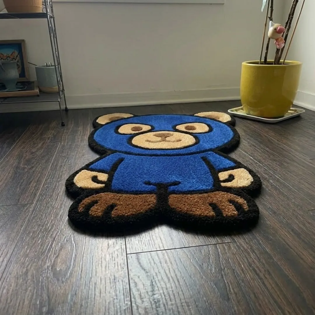 liberty shield shaped area rug perspective detail An angled perspective shot of a hand-tufted liberty shield rug, highlighting its playful bear silhouette and high-quality tufted wool texture on a wooden floor.