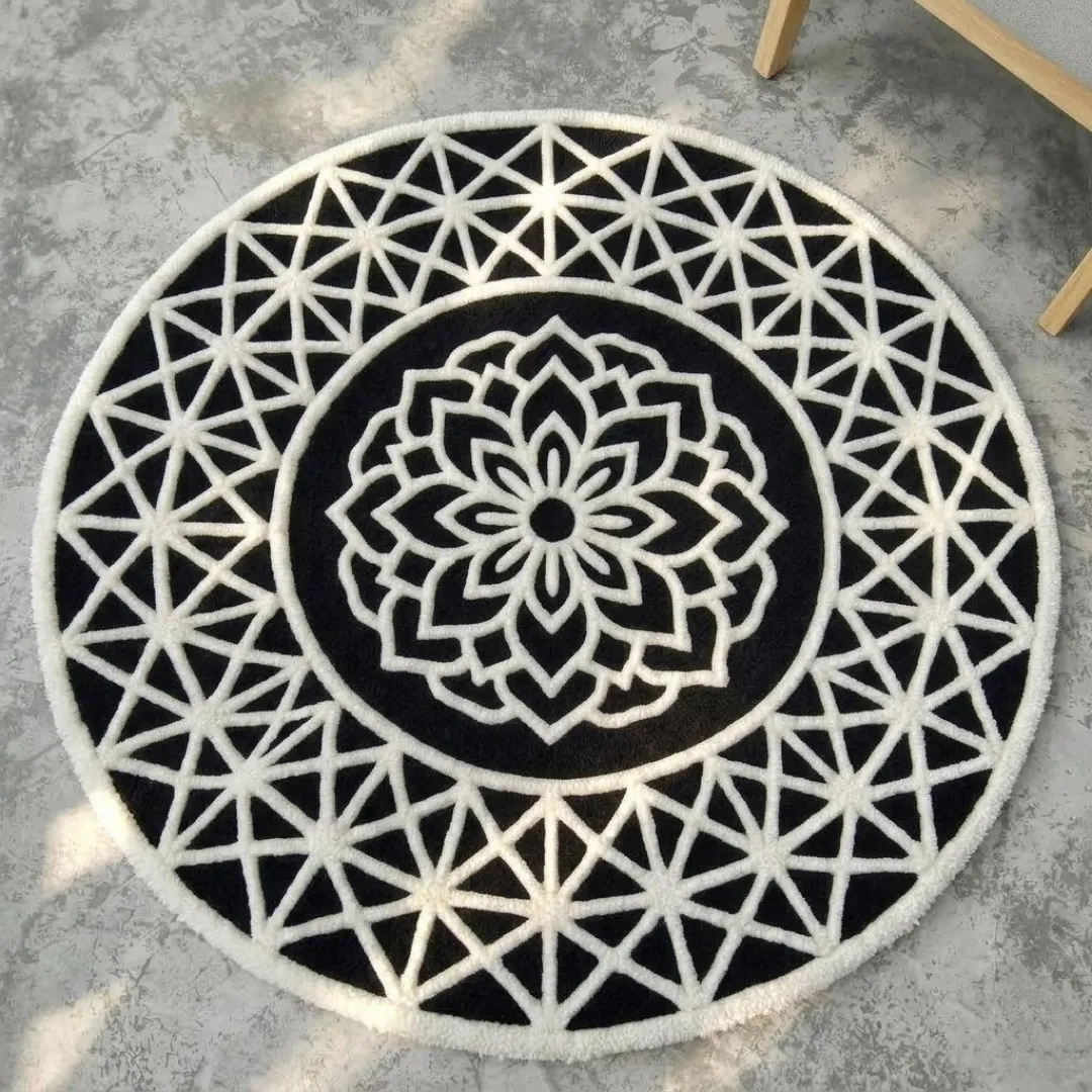 midnight noir crest round rug high angle High-angle shot highlighting the clean contrasting lines, central mandala crest motif, and circular symmetry of the black and white rug.