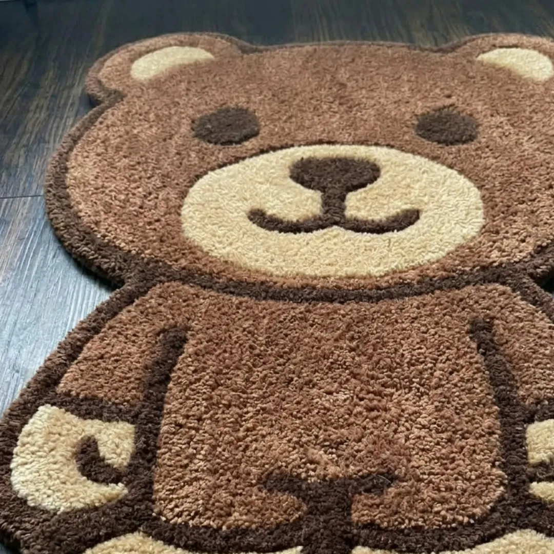 webstrike phantom shaped area rug texture close up A macro close-up of the webstrike phantom rug, focusing on the dense, tufted wool pile and the detailed brown-and-tan color blocking of the bear's facial features.